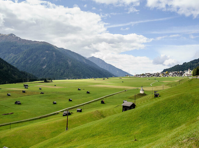 Auf einem großen Schwemmkegel schmiegt sich das Dorf Obertilliach an den Bergfuß der Gailtaler Alpen.