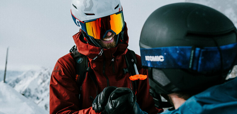 Zwei Skitourengeher sind am Gipfel der Roten Wand im Defereggental in Osttirol angekommen und gratulieren sich gegenseitig zu ihrem Erfolg.