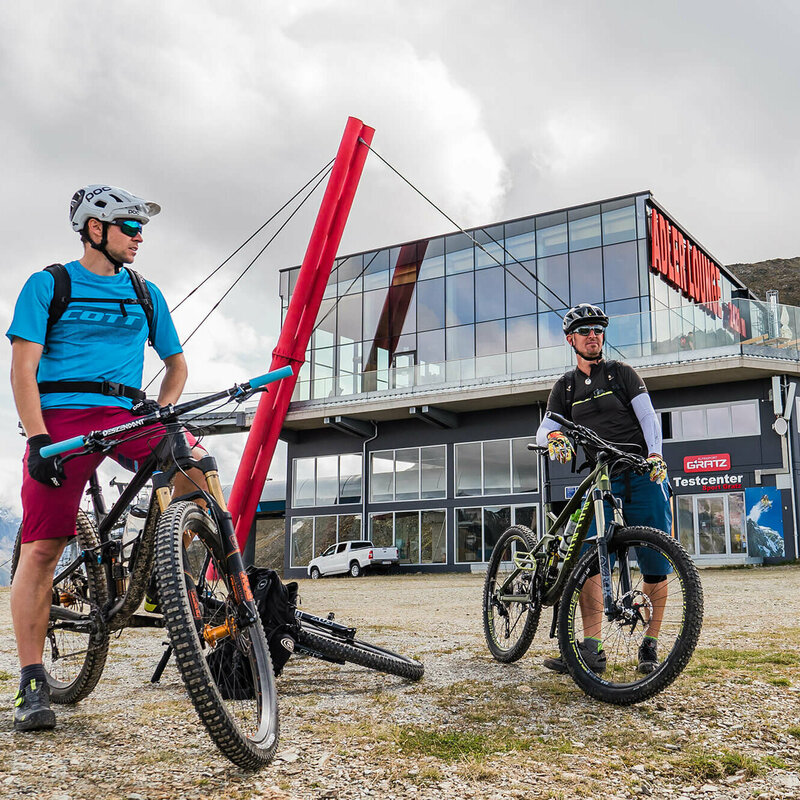 Zwei Biker sind mit ihren Bikes im Adler Lounge Bikepark Grossglockner