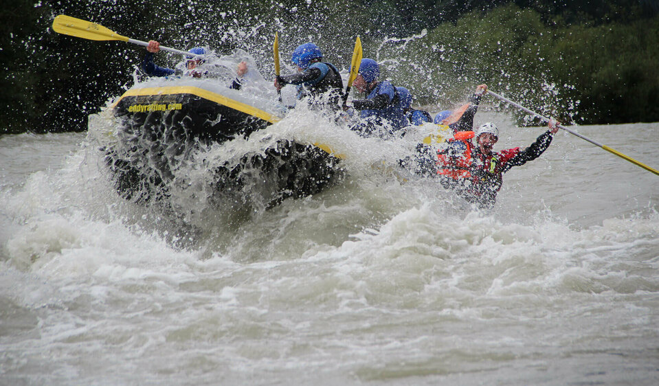 Eine Gruppe Personen sitzt in einem Schlauchboot auf einem reißenden Fluss in Osttirol.